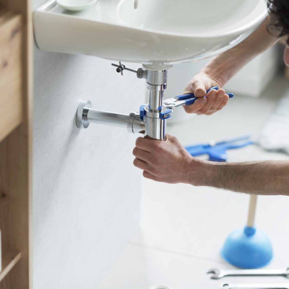 Plumber fixing sink